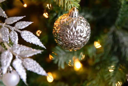 Classic Christmas decorated New year tree. Christmas tree with white and silver decorations, ornaments toy and ball. Modern classical style interior design apartment. Christmas eve at home. photo