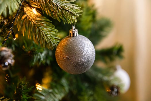 Classic Christmas decorated New year tree. Christmas tree with white and silver decorations, ornaments toy and ball. Modern classical style interior design apartment. Christmas eve at home. photo