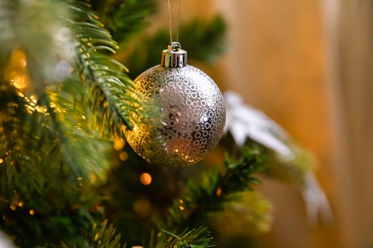 Classic Christmas decorated New year tree. Christmas tree with white and silver decorations, ornaments toy and ball. Modern classical style interior design apartment. Christmas eve at home. photo