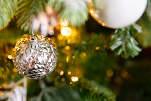 Classic Christmas decorated New year tree. Christmas tree with white and silver decorations, ornaments toy and ball. Modern classical style interior design apartment. Christmas eve at home. photo