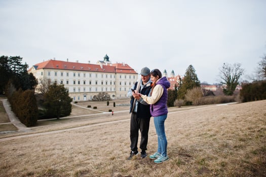 Couple tourist at Valtice palace look on mobile phone, Czech Republic. photo