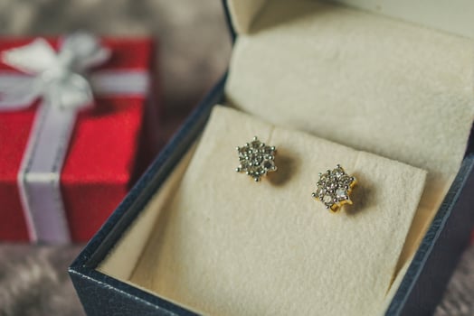 Jewelry gold diamond earring with gift box background photo