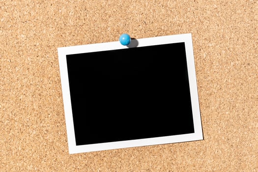 Blank Vintage instant photo frame pinned on corkboard. Template