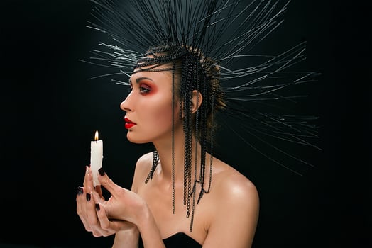 portrait of young beautiful woman like witch with red lips and black crown on dark background. Black dark beauty, Halloween concept photo