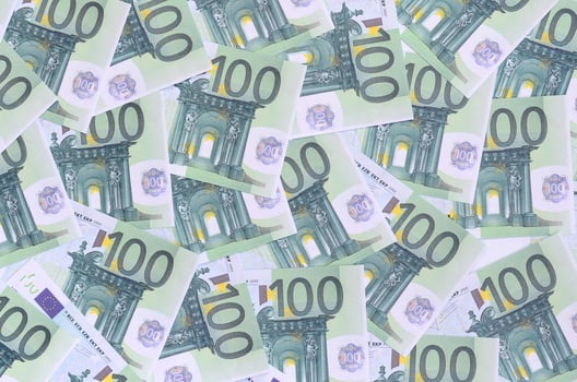 Background pattern of a set of green monetary denominations of 100 euros. A lot of money forms an infinite heap photo
