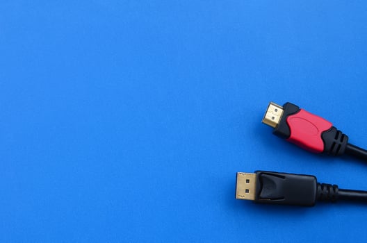 Audio video HDMI computer cable plug and 20-pin male DisplayPort gold plated connector for a flawless connection on a blue background photo
