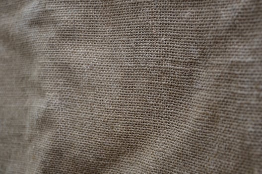 The texture of a very old brown sack cloth. Retro texture with canvas material. Background image with copy space photo