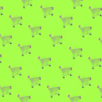Shopping addiction, shopping lover or shopaholic concept. Many small empty shopping carts perform a pattern on a pastel colored paper background. Flat lay composition, top view photo