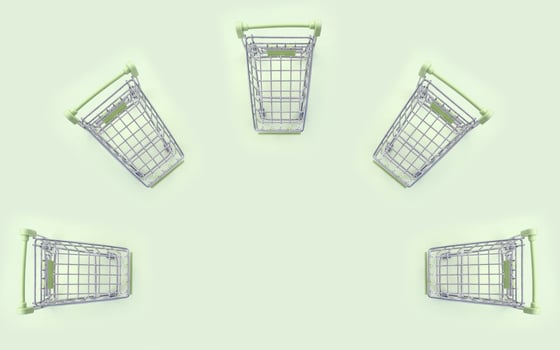 Pattern of many small shopping carts on a lime background photo
