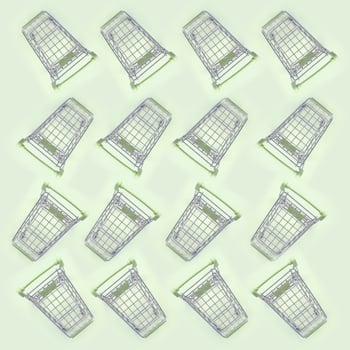 Pattern of many small shopping carts on a lime background photo