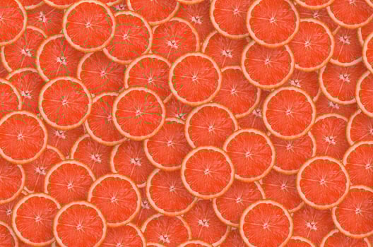 Pattern of red grapefruit citrus slices. Citrus flat lay photo