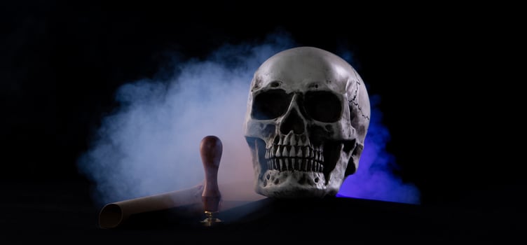 Halloween human skull on an old wooden table over black background. Shape of skull bone for Death head on halloween festival which show lastwill letter stamp interitance ghost spirit, copy space photo