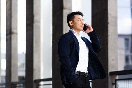 Asian businessman talking on the phone serious has an angry conversation photo