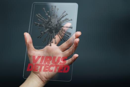 Hand holding and showing virus detected on tablet device. covid-19 photo
