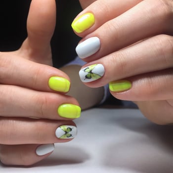 Yellow manicure on the nails. Yellow nail design on the fingers. photo