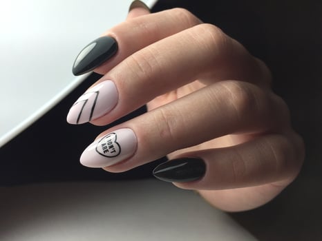 Woman with flesh-colored manicure with design, close up photo