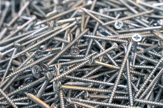 A lot of metal self-tapping screws. background of self-tapping screws. photo