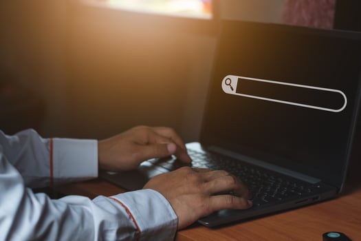 Search informationA business man in the office, using laptop for searching information on the internet, computer and search technology concept photo