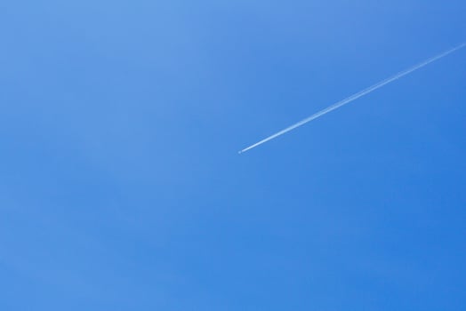 A passenger jet leaves a mark above the blue skies and the start of the airline after the kovic poisoning photo
