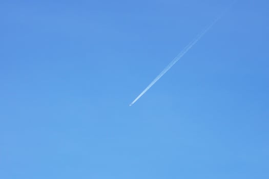 A passenger jet leaves a mark above the blue skies and the start of the airline after the kovic poisoning photo