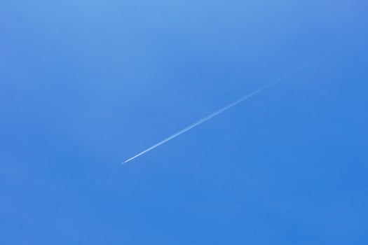 A passenger jet leaves a mark above the blue skies and the start of the airline after the kovic poisoning photo