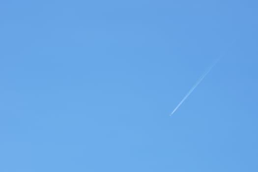 A passenger jet leaves a mark above the blue skies and the start of the airline after the kovic poisoning photo