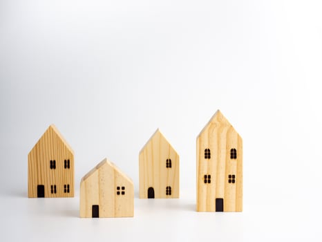 Wooden Miniature houses on white background. photo
