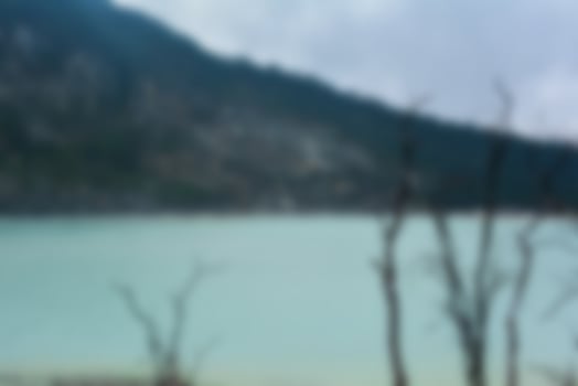 Blurred view of Kawah Putih, white crater, a hot volcanic lake. Tourist destination in South of Bandung, West Java, Indonesia. photo
