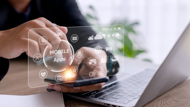 mobile apps concept.Business man hands holding touch screen smartphone outside in the park,color filter,all element graphic are made up by me photo