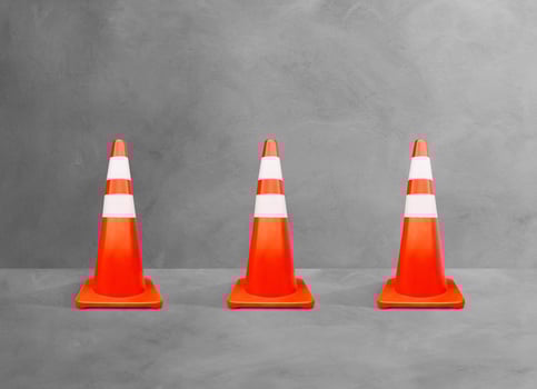 Traffic cones, white-orange poles, isolated on cement floor. photo