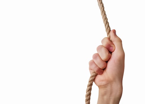 Teenager's hand holding a rope isolated on white background photo