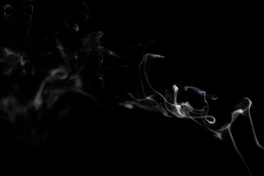 White smoke on black background for layer overlay effect. A realistic smoke or fog effect for photo and video manipulation effect and mystery design theme