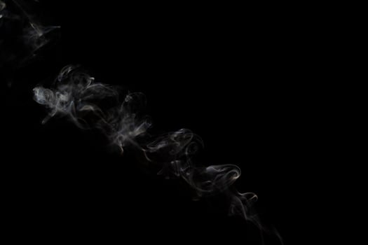 White smoke on black background for layer overlay effect. A realistic smoke or fog effect for photo and video manipulation effect and mystery design theme