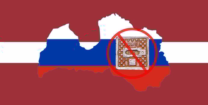 Outline map of Latvia with the image of the national flag. Manhole cover of the gas pipeline system on the flag of Russia inside the map. Collage. Energy crisis. photo