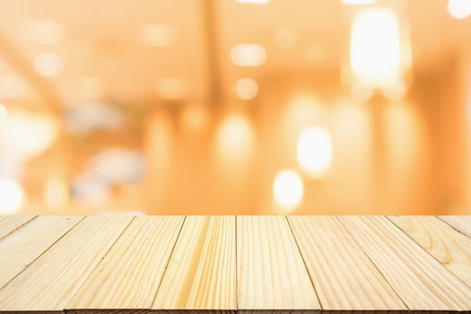 wood table with abstract blurred cafe restaurant with bokeh lights defocused background photo
