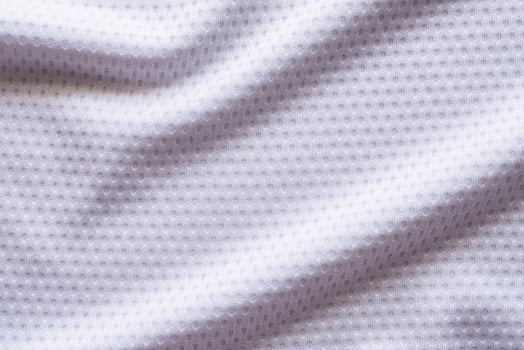 White fabric sport clothing football jersey with air mesh texture background photo
