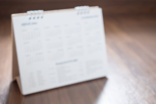 calendar page on wood floor blurred for background photo