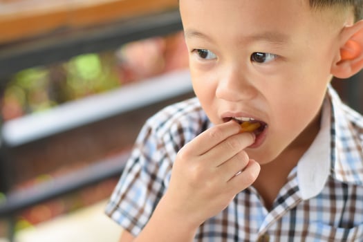 child eating french fries or potato chips. photo