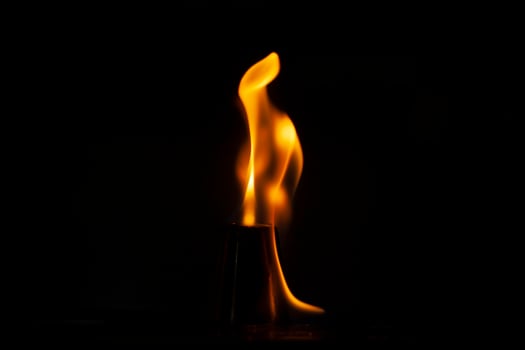 Flames in dark. Tongue of fire one. Alcohol flame retardation. photo