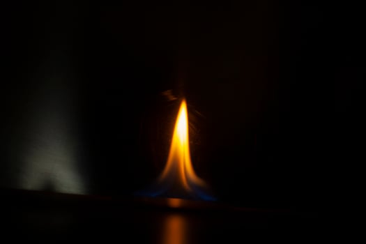 Flames in dark. Tongue of fire one. Alcohol flame retardation. photo