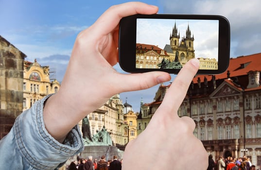 tourist taking photo of old town square in Prague