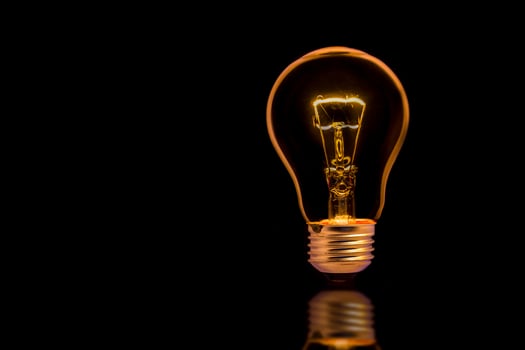 light bulb on black background photo
