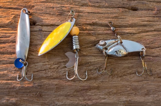 Fishing hook on wood background photo