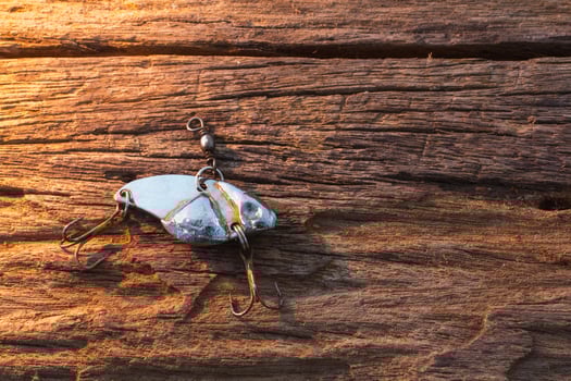 Fishing hook on wood background photo