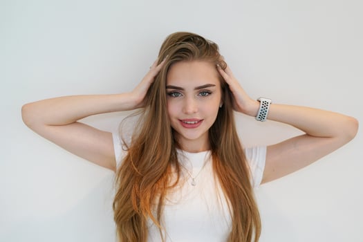 A young woman with long hair and a white shirt photo