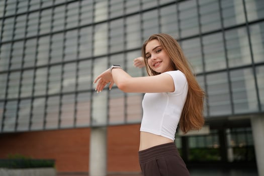A woman is standing in front of a building photo