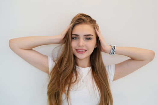 A young woman with long hair and a watch photo