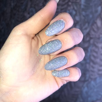 Women's glitter manicure.Silver shiny manicure on nails photo
