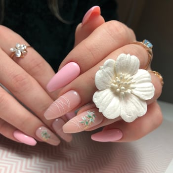 Women's pink manicure with design.Hands of a woman with pink manicure on nails photo
