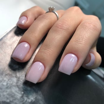 Stylish trendy female pink manicure.Hands of a woman with pink manicure on nails photo